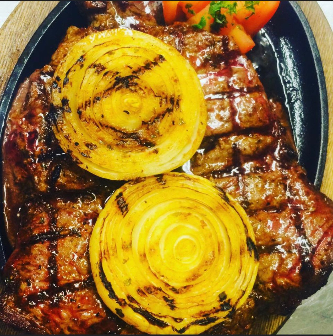 Steak with onions above